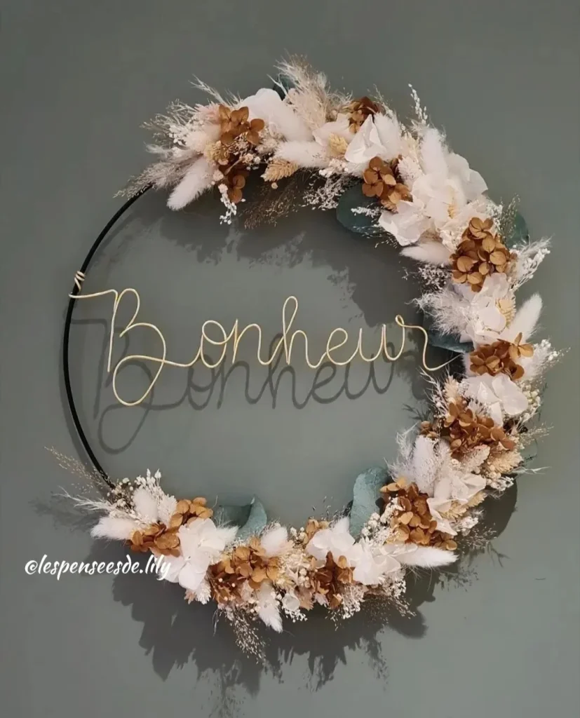 Couronne murale en fleurs séchées blanches, cuivrées et vertes, avec le mot Bonheur en fil doré sur cercle noir - Les Pensées de Lily