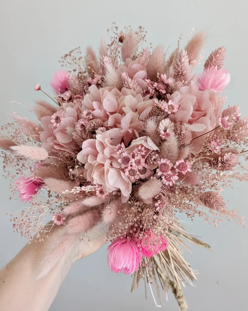 Bouquet en fleurs séchées dans des tons rose poudré et fuchsia porté à la main - Les pensées de Lily